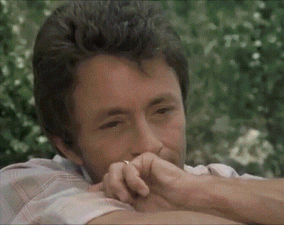 A Man With A Ring On His Finger Looks At The Camera GIF