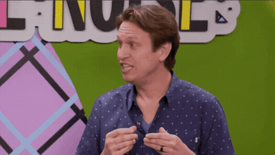 A Man With A Ring On His Finger Stands In Front Of A Sign That Says ' Language ' GIF