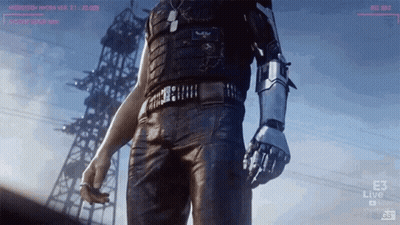 A Man With A Robot Arm Is Standing In Front Of A Tower GIF