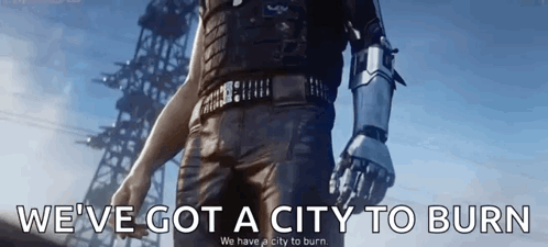 A Man With A Robot Arm Is Walking In Front Of A Building With The Words `` We 'Ve Got A City To Burn '' GIF