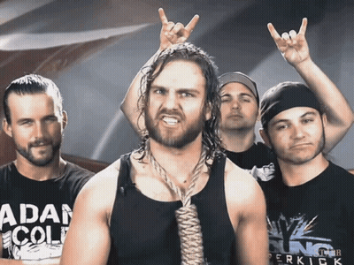 A Man With A Rope Around His Neck Is Wearing A Shirt That Says " Adam Cole " GIF