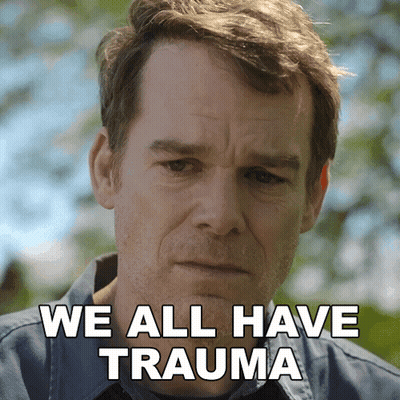 a man with a sad look on his face and the words " we all have trauma " behind him