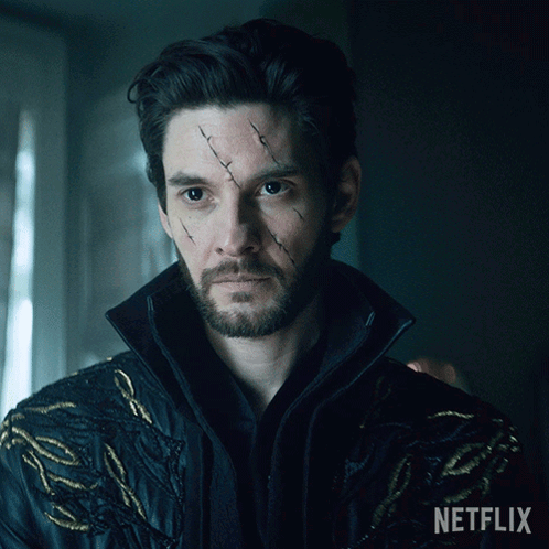 A Man With A Scar On His Face Is Wearing A Jacket That Says Netflix On It GIF