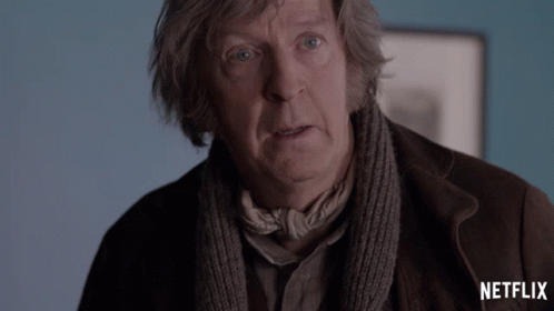 A Man With A Scarf Around His Neck And The Word Netflix On The Bottom Right GIF