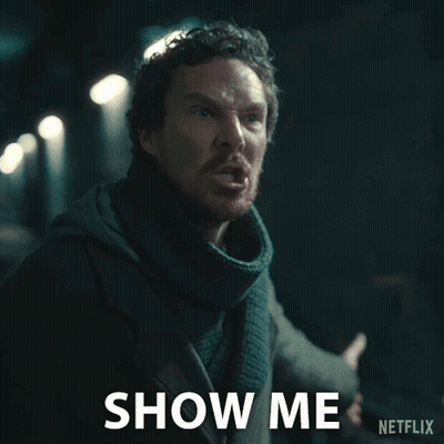 A Man With A Scarf Around His Neck Says Show Me On A Netflix Ad GIF