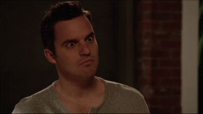 A Man With A Serious Look On His Face Is Next To A Sign That Says What Do You Mean GIF