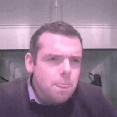 A Man With A Serious Look On His Face Is Wearing A Sweater GIF