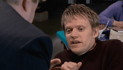 A Man With A Serious Look On His Face Talking To Another Man GIF
