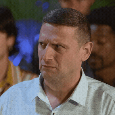 A Man With A Serious Look On His Face Wears A White Shirt GIF