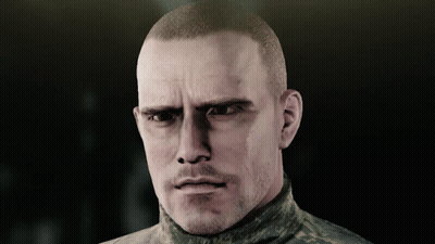 A Man With A Shaved Head And A Beard Looks At The Camera GIF