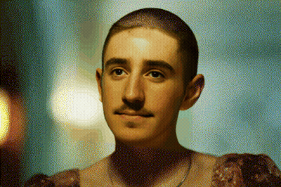 A Man With A Shaved Head And A Mustache Is Wearing A Dress GIF