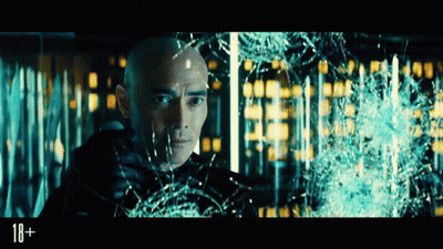A Man With A Shaved Head Is Looking Through A Broken Glass Window With The Number 18 On The Bottom GIF