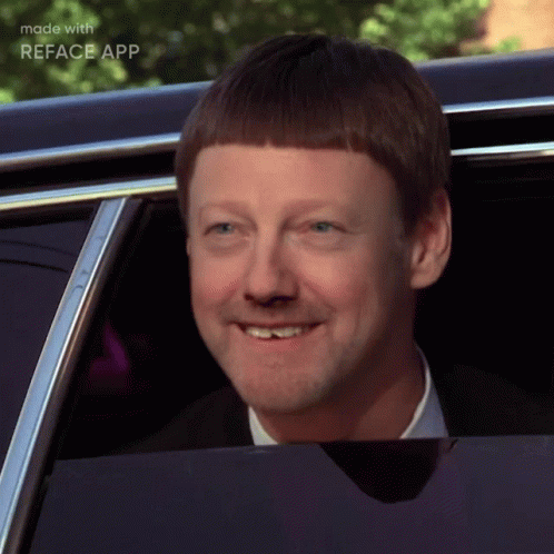 A Man With A Shaved Head Is Smiling In A Car With The Words Made With Reface App Below Him GIF