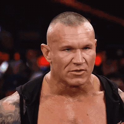 A Man With A Shaved Head Is Wearing A Black Hoodie GIF