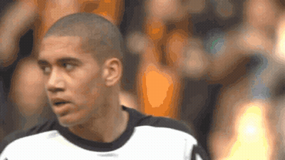 A Man With A Shaved Head Is Wearing A White Shirt GIF