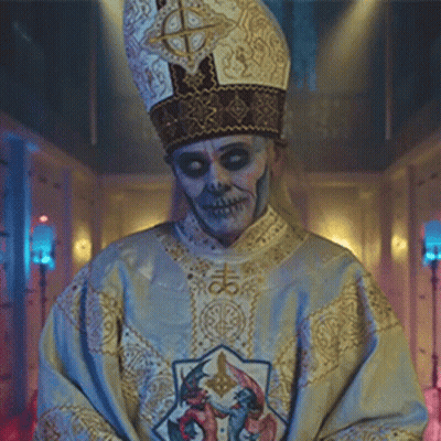A Man With A Skull Face Painted On His Face Is Wearing A Priest 'S Robe And Hat . GIF