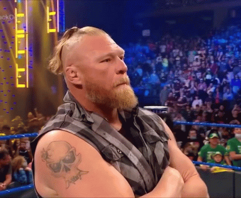 A Man With A Skull Tattoo On His Arm Is Standing In Front Of A Crowd GIF