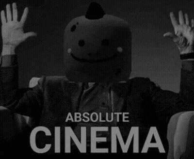 A Man With A Smiley Face On His Head Is Sitting In A Chair With His Hands In The Air And The Words Absolute Cinema Below GIF
