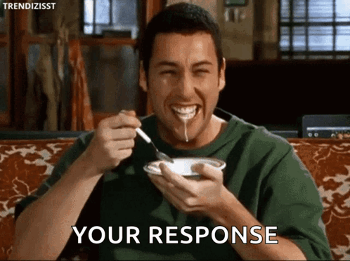 A Man With A Spoon In His Mouth Is Eating A Bowl Of Food And Says Your Response GIF