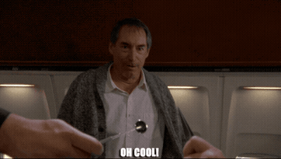 A Man With A Spoon In His Shirt Is Being Held By Someone With The Words Oh Cooli Written On The Bottom GIF