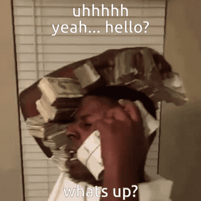 A Man With A Stack Of Money On His Head Talking On A Phone GIF
