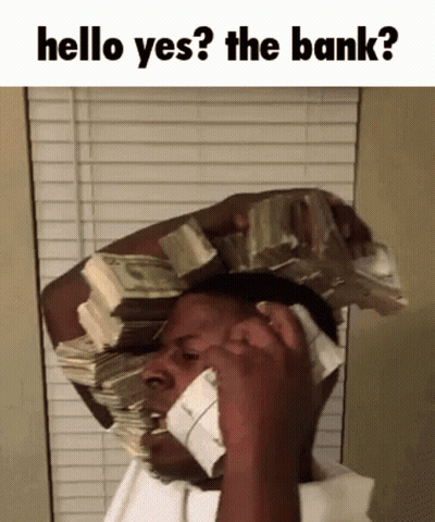 A Man With A Stack Of Money On His Head Talking On A Phone GIF