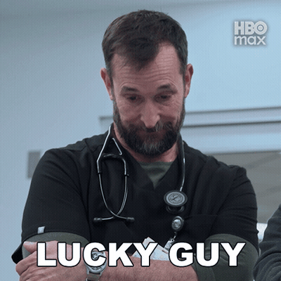 A Man With A Stethoscope Around His Neck Says " Lucky Guy " In White Letters GIF