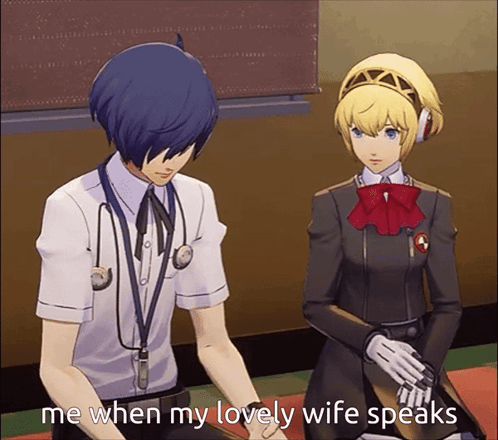A Man With A Stethoscope Around His Neck Sits Next To A Woman With A Red Bow On Her Head GIF