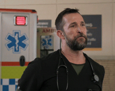 A Man With A Stethoscope Around His Neck Stands In Front Of An Ambulance GIF