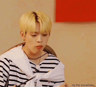 A Man With A Striped Shirt Is Eating Something With Chopsticks And The Words Mj The Snowman Below Him GIF