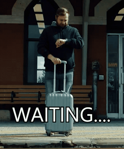 A Man With A Suitcase Is Looking At His Watch And The Word Waiting Is Behind Him GIF