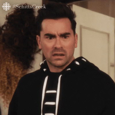 A Man With A Surprised Look On His Face And The Hashtag Schitts Creek GIF