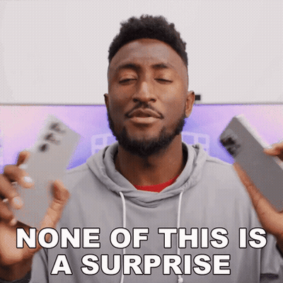 A Man With A Surprised Look On His Face And The Words None Of This Is A Surprise Below Him GIF