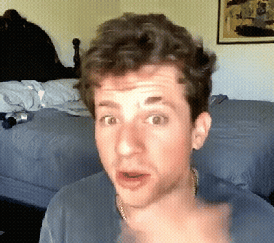 A Man With A Surprised Look On His Face Is Pointing At The Camera GIF