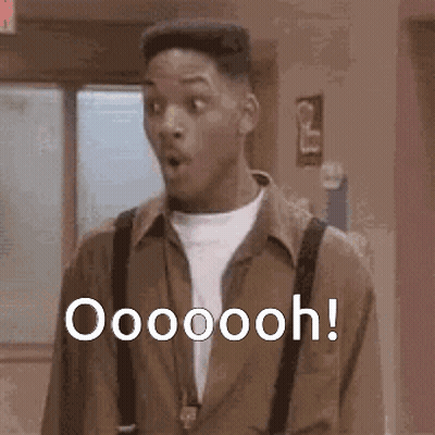 A Man With A Surprised Look On His Face Is Standing In A Hallway And Says Oooooooh ! GIF