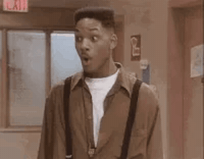 A Man With A Surprised Look On His Face Is Standing In A Hallway With The Word Rad Written On The Bottom . GIF
