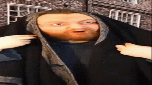 A Man With A Surprised Look On His Face Is Wearing A Black Cape GIF