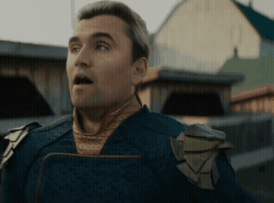 A Man With A Surprised Look On His Face Is Wearing A Blue Costume GIF