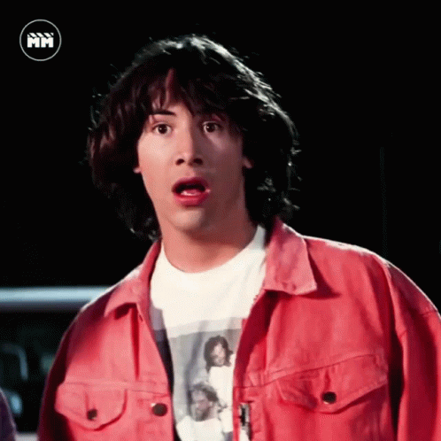 A Man With A Surprised Look On His Face Is Wearing A Red Shirt GIF