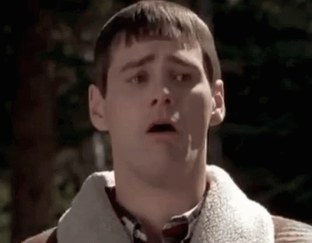 A Man With A Surprised Look On His Face Is Wearing A Sweater And A Plaid Shirt . GIF