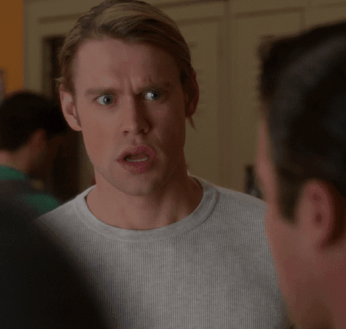 A Man With A Surprised Look On His Face Looks At Another Man GIF