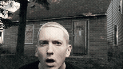 A Man With A Surprised Look On His Face Stands In Front Of A House That Says 1990 On The Door GIF