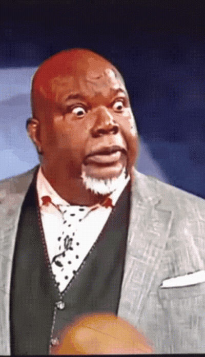 A Man With A Surprised Look On His Face Wearing A Suit And Tie GIF