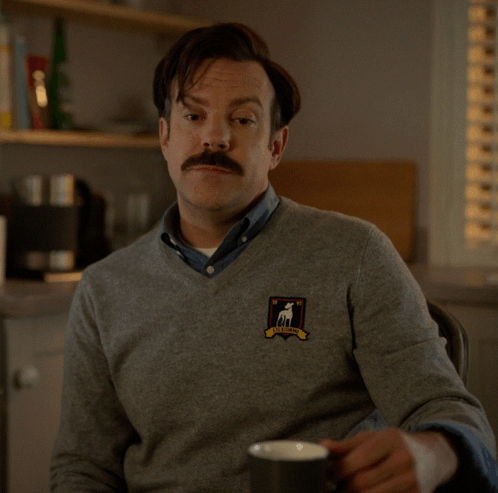 A Man With A Sweater That Says I 'D Call You A Big Dumb Poo-Poo Face GIF