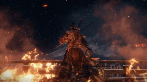 A Man With A Sword Stands In Front Of A Burning Building GIF
