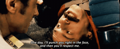 A Man With A Tag That Says Cad On It Is Talking To Another Man GIF