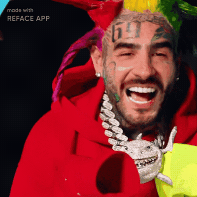 A Man With A Tattoo Of The Number 69 On His Face Is Smiling GIF