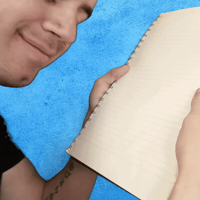 A Man With A Tattoo On His Arm Holds A Notebook GIF