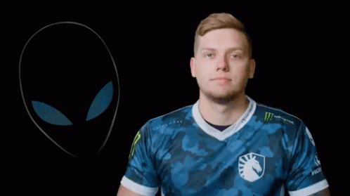 A Man With A Tattoo On His Arm Holds A Pair Of Headphones GIF