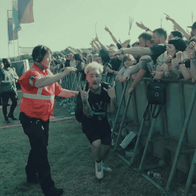 a man with a tattoo on his arm is being escorted by a security officer